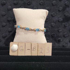 Item # GB23  10K Gold 7 in Tennis Bracelet with Blue Topaz and Tiny Diamonds